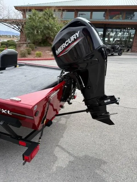 Slide: The Image of 2025 Tracker Bass Tracker Classic XL with Mercury outboard motor, parked outdoors. - 4