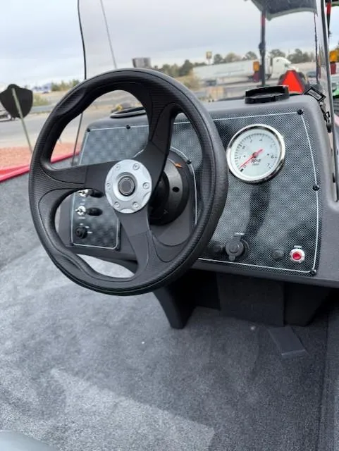 Slide: The Image of 2025 Tracker Bass Tracker Classic XL dashboard with steering wheel and gauge. - 5