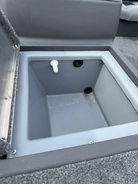 Slide: The Image of 2025 Tracker Bass Tracker Classic XL livewell compartment with open lid, showcasing interior features. - 6