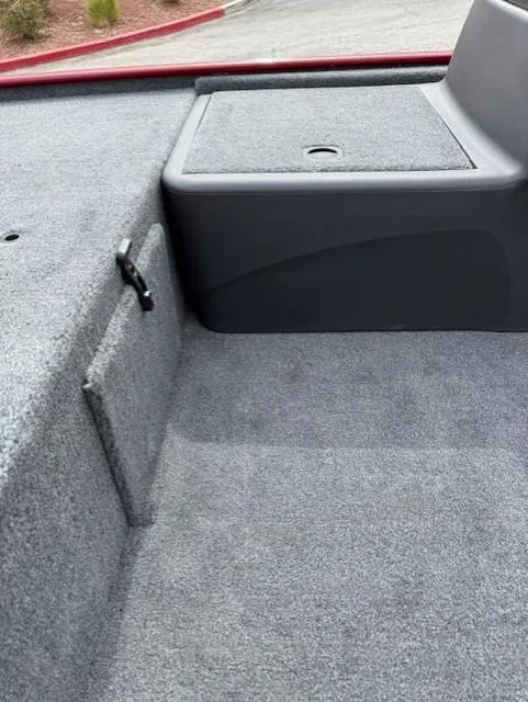 Slide: The Image of 2025 Tracker Bass Tracker Classic XL boat interior with carpeted storage compartment. - 9