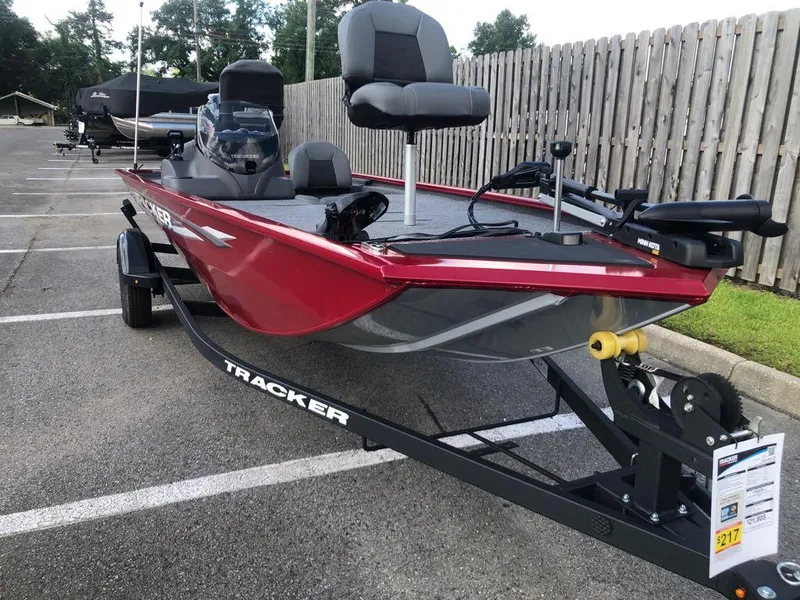 Slide: The Image of 2025 Tracker Pro 170 boat in parking lot, red exterior, on trailer. - 11