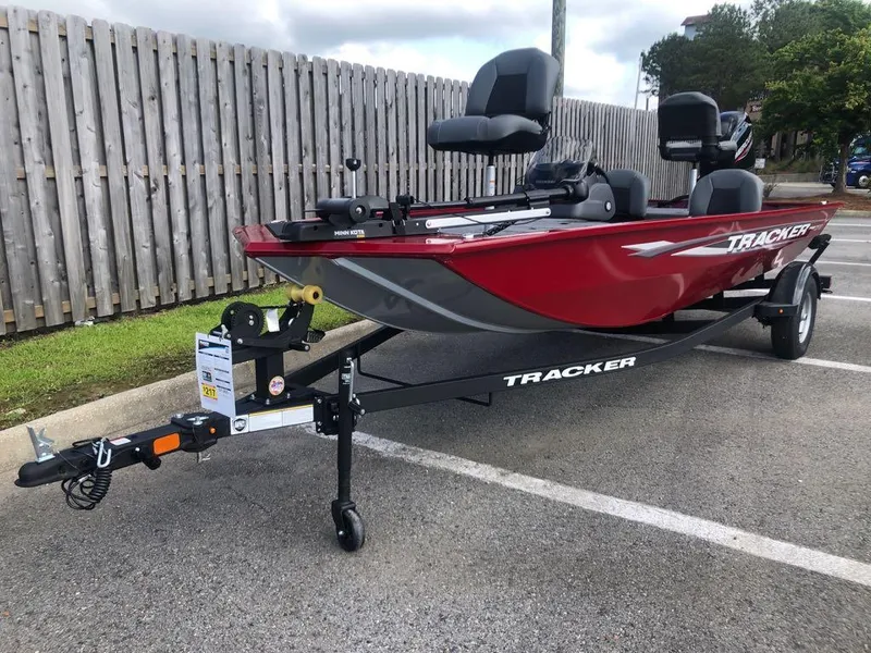 Slide: The Image of 2025 Tracker Pro 170 boat in parking lot, red exterior, on trailer. - 14