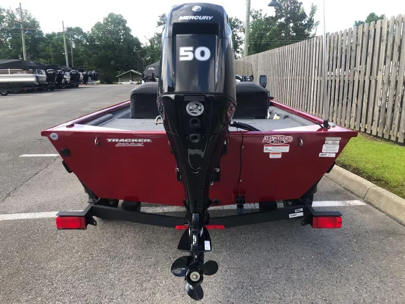 Slide: The Image of 2025 Tracker Pro 170 boat with Mercury 50 engine, parked in a lot. - 2