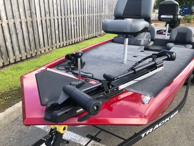 Slide: The Image of 2025 Tracker Pro 170 boat with trolling motor and seating, parked outdoors. - 5