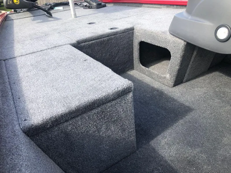 Slide: The Image of 2025 Tracker Pro 170 boat interior with gray carpeted storage compartments. - 7