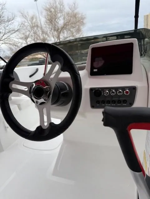 Slide: The Image of Steering wheel and dashboard of 2025 Tahoe T16 boat with control panel and display. - 6