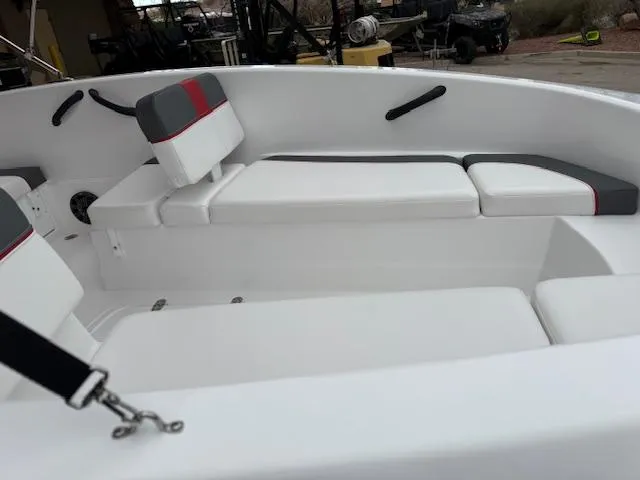Slide: The Image of 2025 Tahoe T16 boat interior with white and gray seating, featuring red accents. - 9