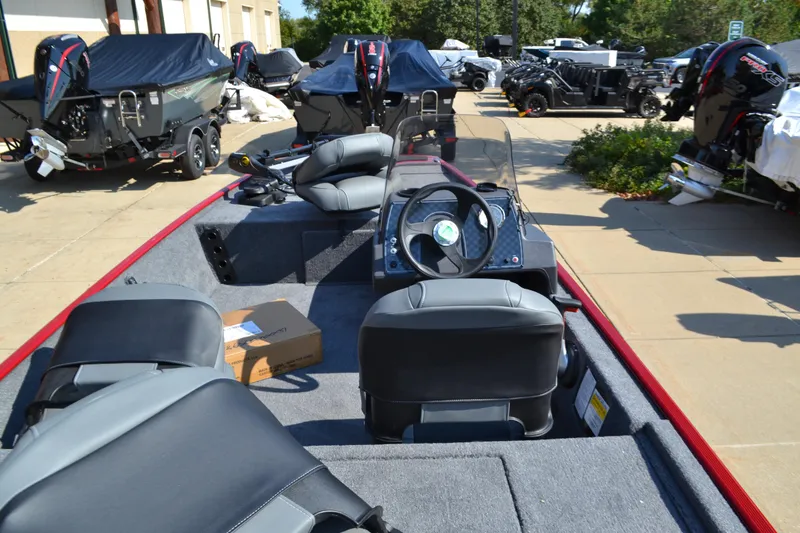 Slide: The Image of 2025 Tracker Bass Tracker Classic XL boat interior with seating and steering wheel. - 2