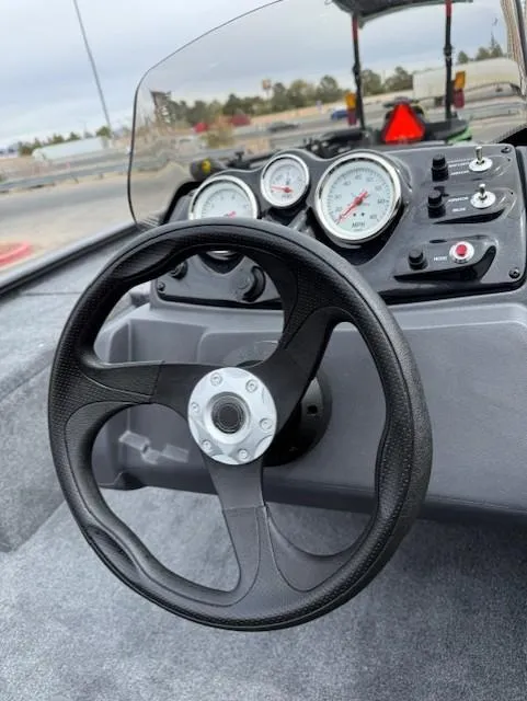 Slide: The Image of Steering wheel and dashboard of 2025 Tracker Pro 170 boat, featuring gauges and controls. - 3