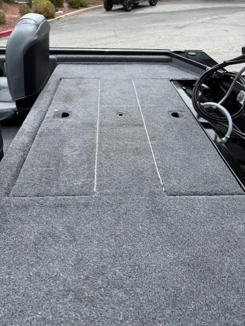 Slide: The Image of 2025 Tracker Pro 170 boat interior with gray carpeted deck and seating. - 5