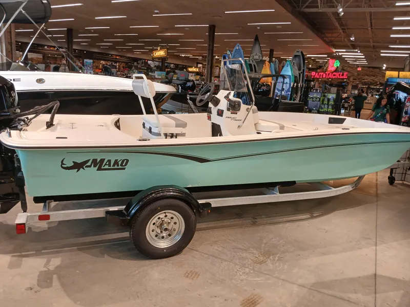 The Image of 2025 Mako Pro Skiff 17 CC boat displayed indoors on a trailer. - 0