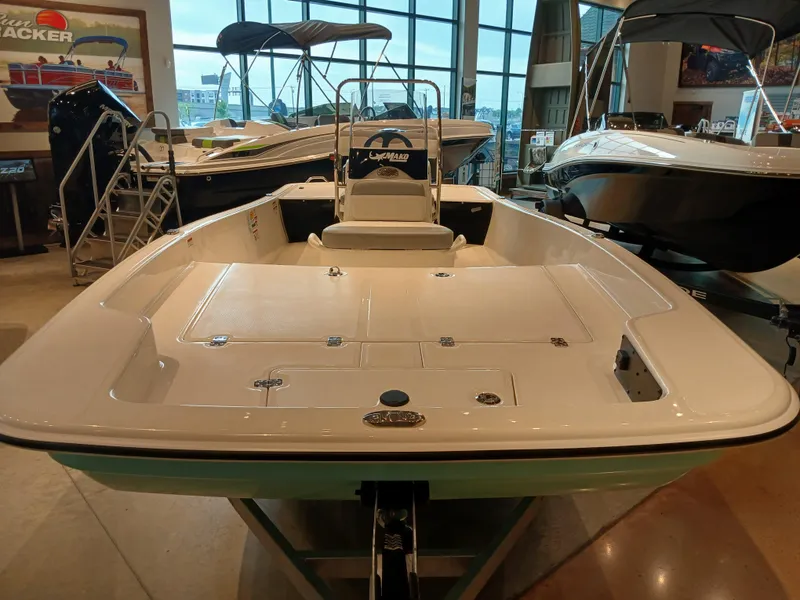 Slide: The Image of 2025 Mako Pro Skiff 17 CC boat displayed in showroom. - 3