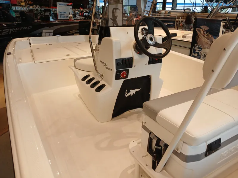Slide: The Image of 2025 Mako Pro Skiff 17 CC boat interior with steering console and seating. - 7