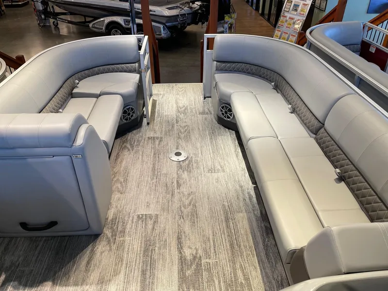 Slide: The Image of 2025 Ranger Reata 220C pontoon boat interior with spacious seating and modern design. - 1