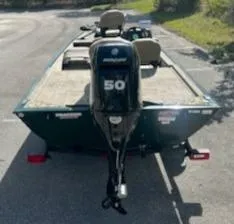 Slide: The Image of 2025 Tracker Bass Tracker Classic Limited boat with Mercury 50 engine, parked on a trailer. - 10