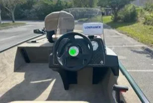 Slide: The Image of 2025 Tracker Bass Tracker Classic Limited boat interior with steering wheel and Lowrance equipment. - 2