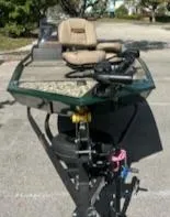 Slide: The Image of 2025 Tracker Bass Tracker Classic Limited boat with seating and equipment, parked outdoors. - 6