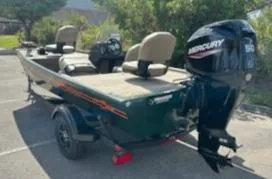 Slide: The Image of 2025 Tracker Bass Tracker Classic Limited boat with Mercury engine in a parking lot. - 8