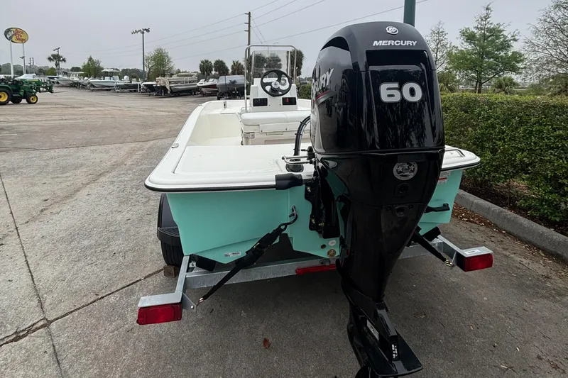 Slide: The Image of 2025 Mako Pro Skiff 15 CC with Mercury 60 outboard motor on trailer. - 3