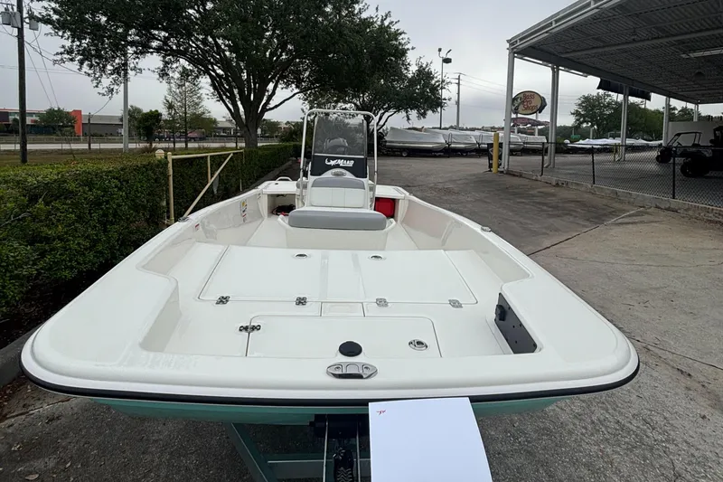 Slide: The Image of 2025 Mako Pro Skiff 15 CC boat on display in outdoor setting. - 4