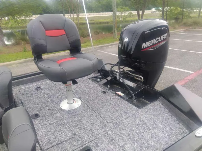 Slide: The Image of 2025 Tracker Pro Team 175 boat with Mercury engine and seating in a parking lot. - 12