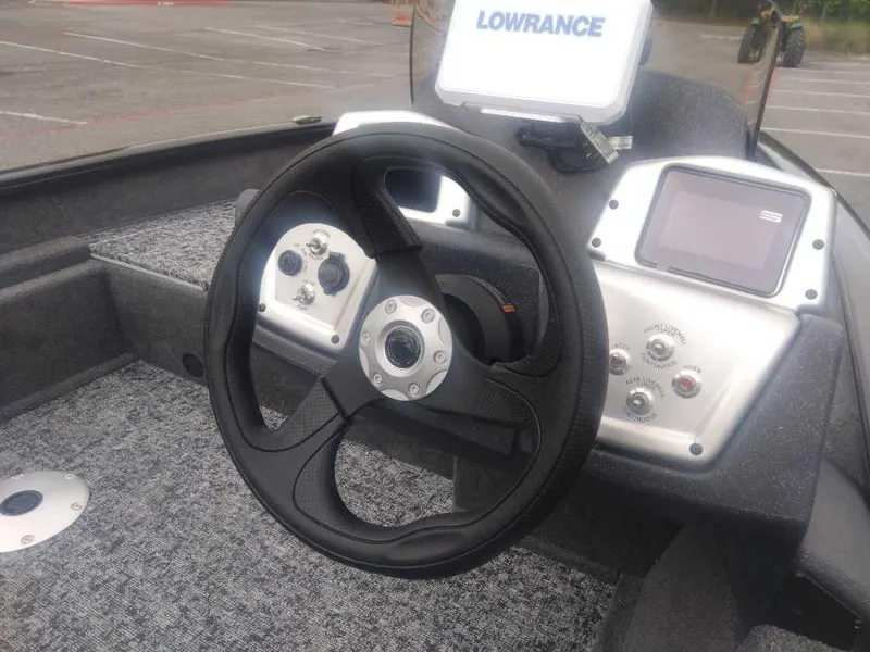 Slide: The Image of 2025 Tracker Pro Team 175 boat dashboard with steering wheel and Lowrance display. - 13