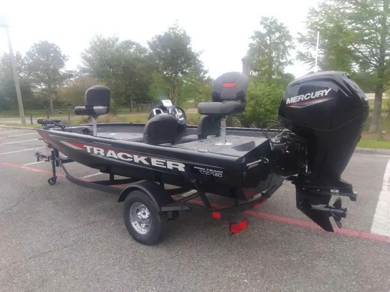 Slide: The Image of 2025 Tracker Pro Team 175 boat with Mercury engine in a parking lot. - 2