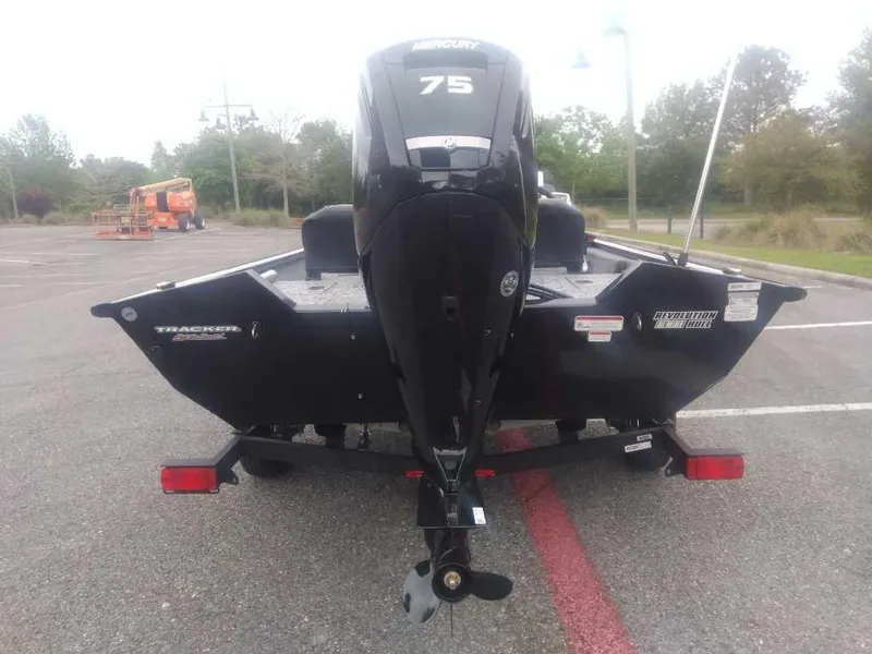Slide: The Image of 2025 Tracker Pro Team 175 boat with 75 HP engine in parking lot. - 3