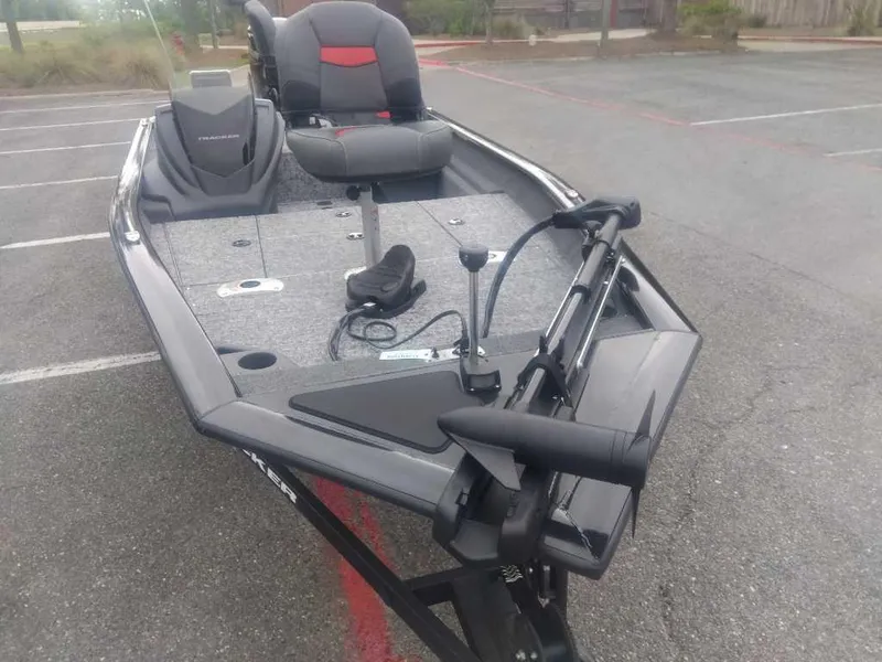 Slide: The Image of 2025 Tracker Pro Team 175 fishing boat in a parking lot. - 8