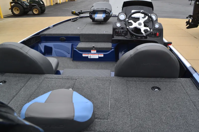 Slide: The Image of Interior view of a 2025 Nitro Z17 boat, featuring seating and steering console. - 3
