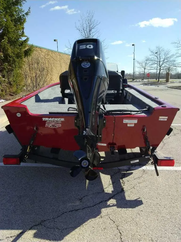 Slide: The Image of 2025 Tracker Super Guide V-16 SC boat with powerful outboard motor, parked outdoors. - 3
