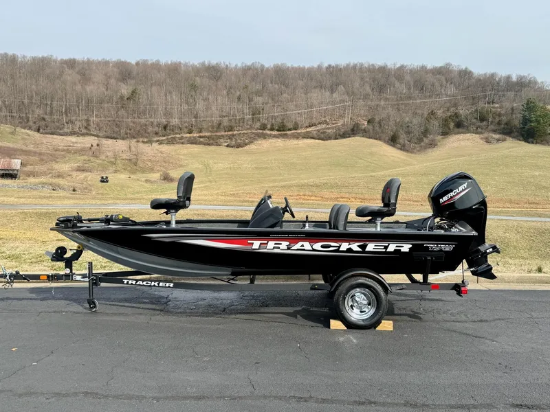 Slide: The Image of 2025 Tracker Pro Team 175 Crappie Edition boat on trailer, parked outdoors. - 2