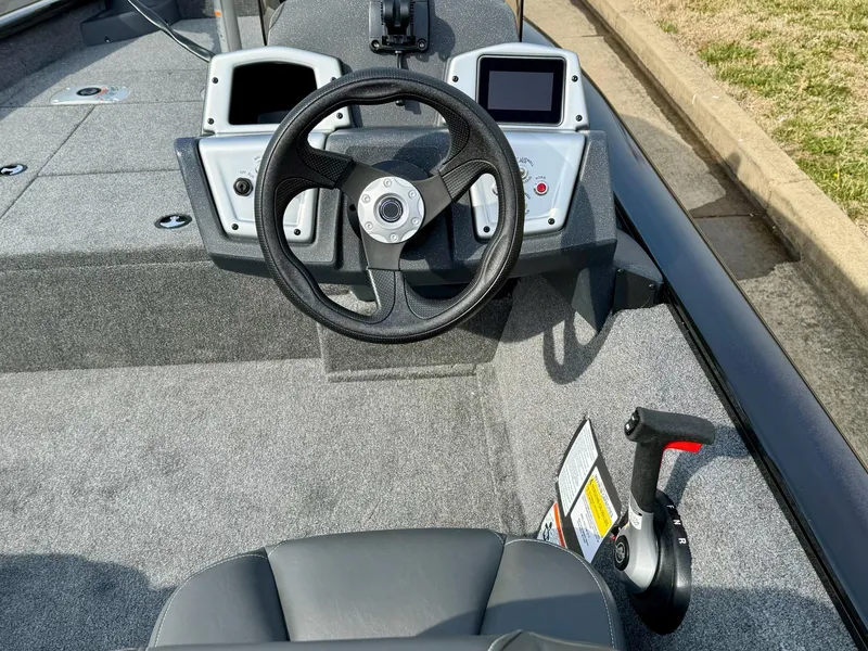 Slide: The Image of 2025 Tracker Pro Team 175 Crappie Edition boat interior with steering wheel and controls. - 5