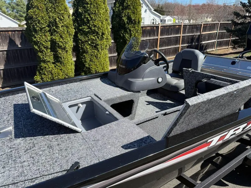 Slide: The Image of 2025 Tracker Pro 170 boat interior with open storage compartments and steering console. - 3