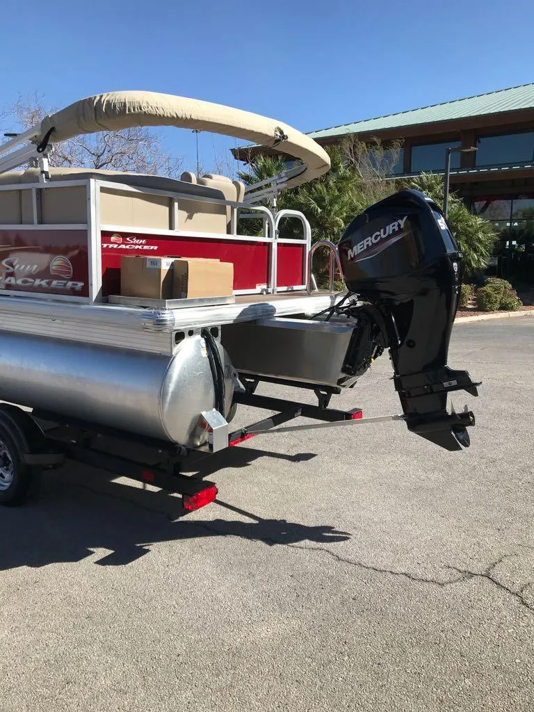 Slide: The Image of 2025 Sun Tracker Bass Buggy 16 XL Select pontoon boat with Mercury outboard motor. - 2