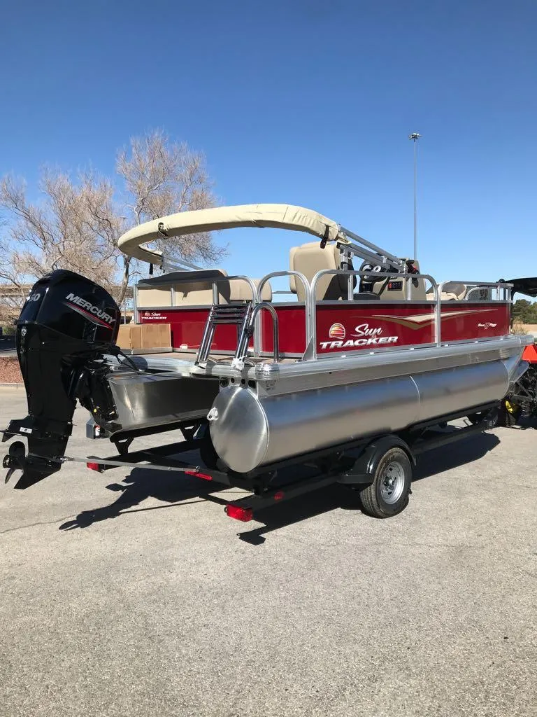 Slide: The Image of 2025 Sun Tracker Bass Buggy 16 XL Select pontoon boat with Mercury outboard motor. - 4