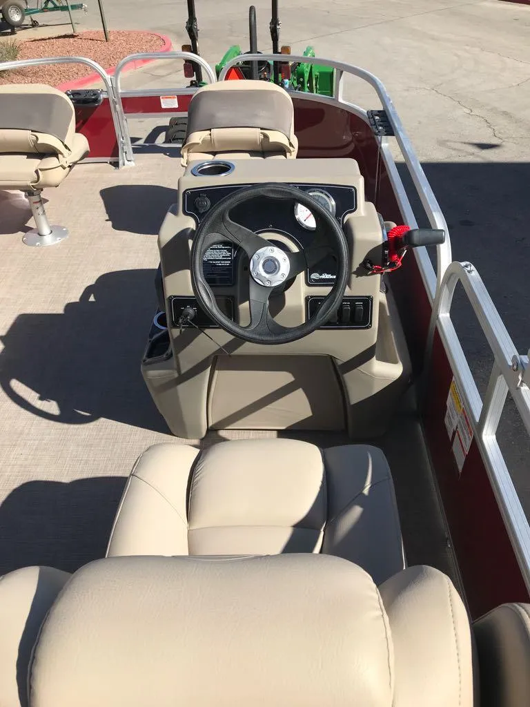 Slide: The Image of 2025 Sun Tracker Bass Buggy 16 XL Select pontoon boat interior with steering console. - 6
