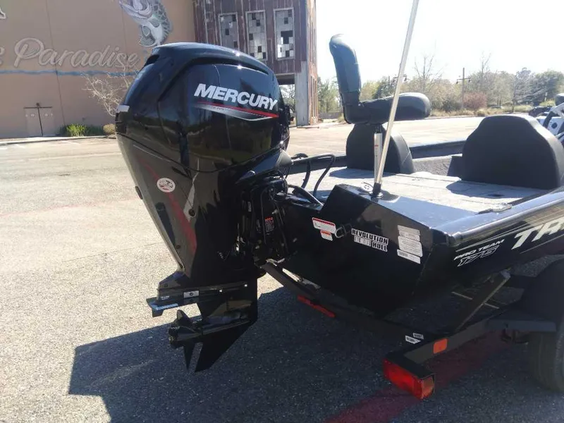Slide: The Image of 2025 Tracker Pro Team 175 boat with Mercury outboard motor in a parking lot. - 4