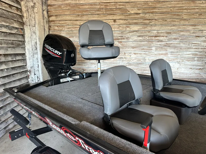 Slide: The Image of 2025 Tracker Bass Tracker Classic XL boat with Mercury engine and three gray seats. - 2