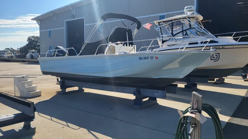 The Image of 2024 Boston Whaler 210 Montauk boat on display at a marina. - 0