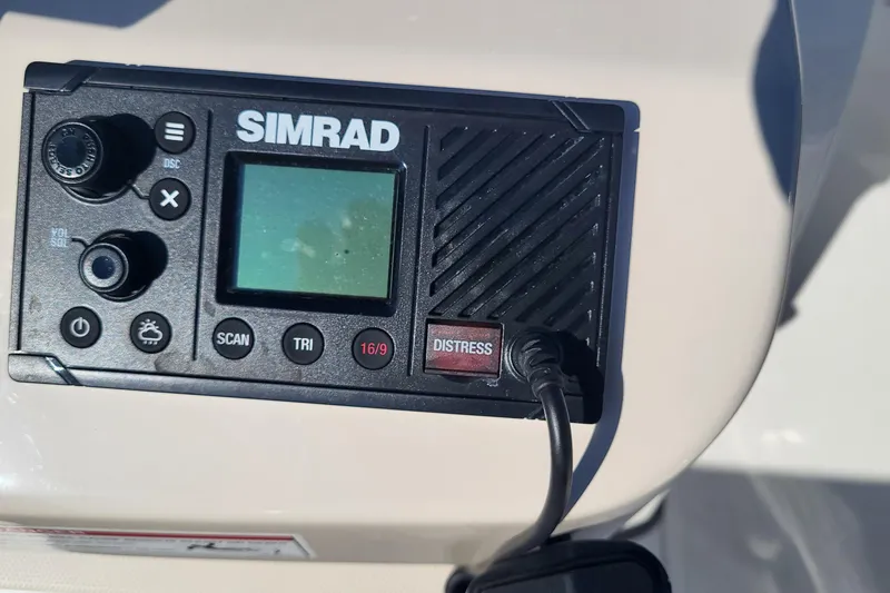 Slide: The Image of Simrad marine radio on 2024 Boston Whaler 210 Montauk boat dashboard. - 12