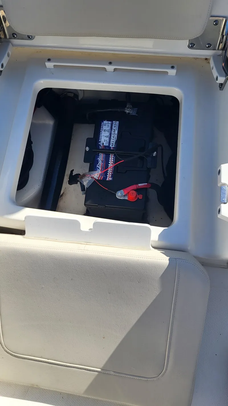 Slide: The Image of 2024 Boston Whaler 210 Montauk boat battery compartment with visible wiring. - 13