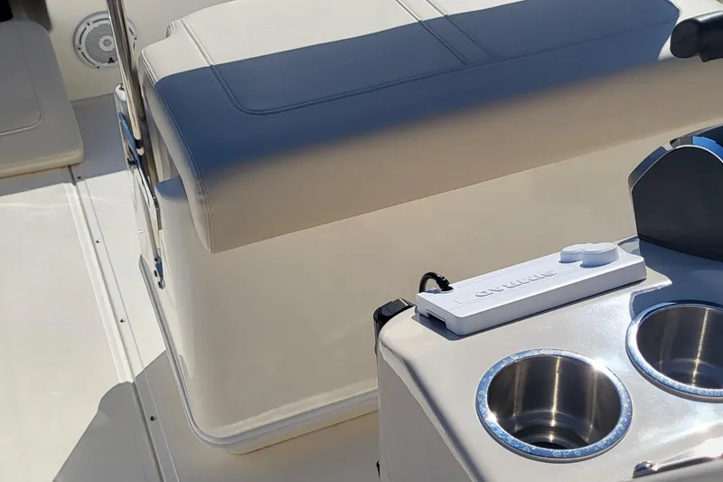 Slide: The Image of 2024 Boston Whaler 210 Montauk boat interior with seating and cup holders. - 14