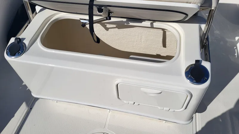 Slide: The Image of 2024 Boston Whaler 210 Montauk boat storage compartment with cup holders. - 15