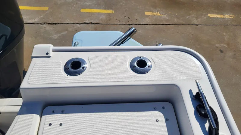 Slide: The Image of 2024 Boston Whaler 210 Montauk boat deck with rod holders and cleat. - 16