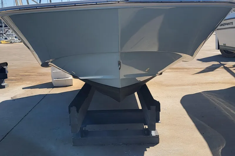 Slide: The Image of 2024 Boston Whaler 210 Montauk boat on a stand, viewed from the front. - 2