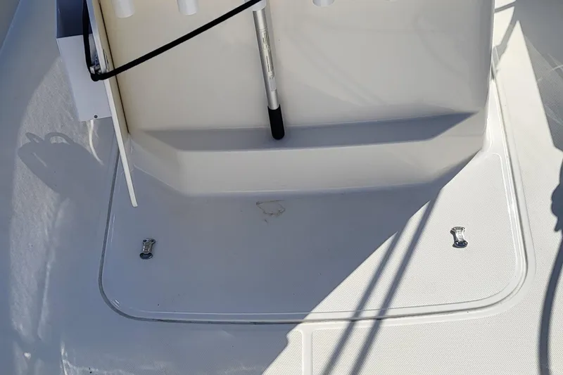 Slide: The Image of 2024 Boston Whaler 210 Montauk boat deck with storage compartment and rod holder. - 21