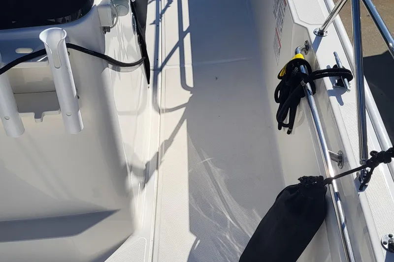 Slide: The Image of 2024 Boston Whaler 210 Montauk deck with rod holders and safety railings. - 22