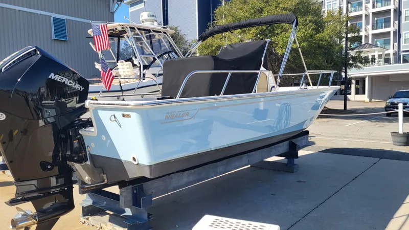 Slide: The Image of 2024 Boston Whaler 210 Montauk boat on display, featuring a Mercury outboard motor. - 3