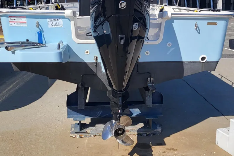 Slide: The Image of 2024 Boston Whaler 210 Montauk boat, rear view with outboard motor, on a stand. - 5